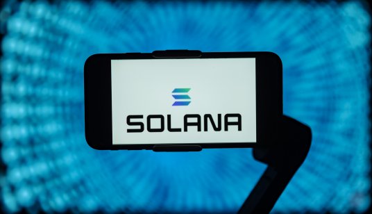 The Solana (SOL) logo is displayed on a smartphone